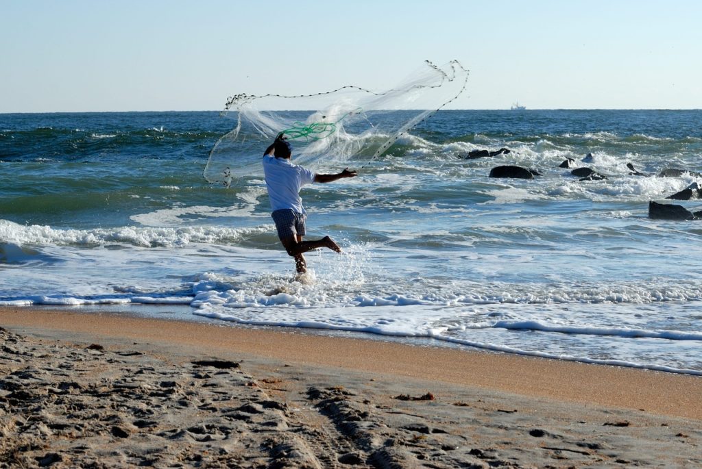 cast netting on the beach